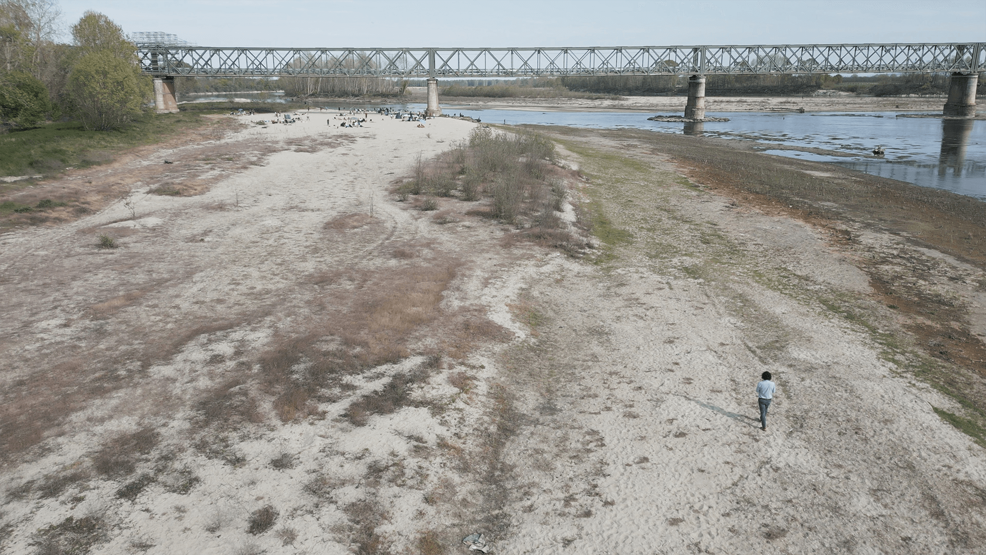 aerial shot of a man walking in the dry riverbed of the River Po